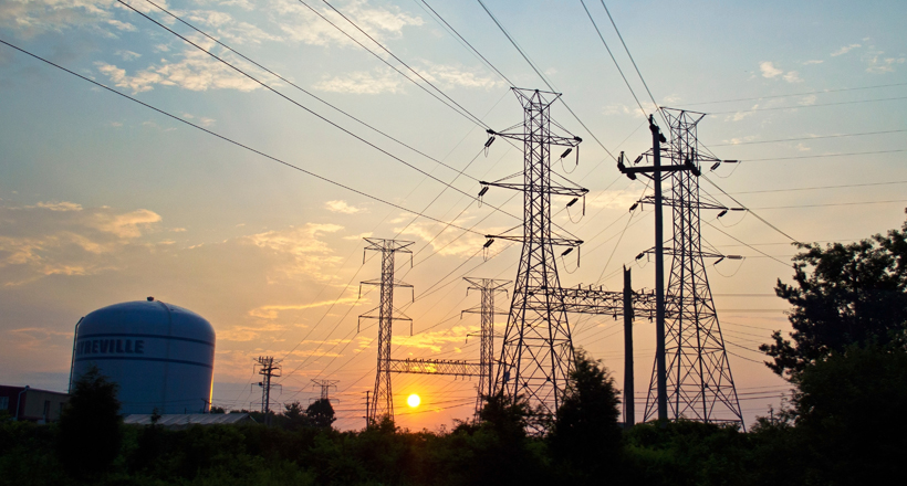 electrical towers and industrial storage tanks at sunrise in Sayerville NJ